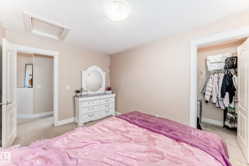 The room features neutral-toned walls, carpeted flooring, and a ceiling light fixture - 11415 167A Avenue, Edmonton, AB - Indoor Photo Showing Bedroom