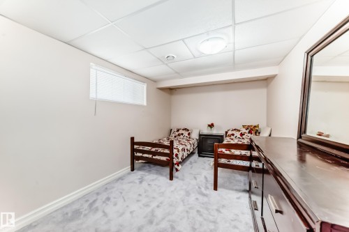 This room features a window with blinds, light-colored walls, and a light-toned carpet - 11415 167A Avenue, Edmonton, AB - Indoor Photo Showing Other Room