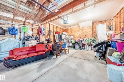 Attached garage with exposed wood beam ceiling and concrete flooring - 11415 167A Avenue, Edmonton, AB - Indoor Photo Showing Garage