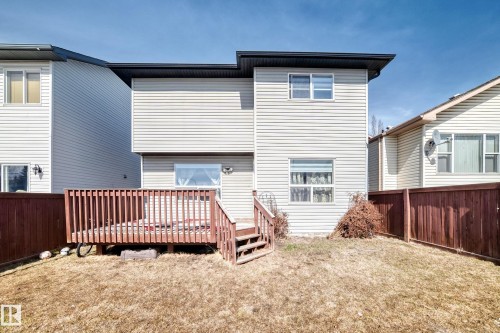 The property includes a wooden deck with railing, accessible via stairs - 11415 167A Avenue, Edmonton, AB - Outdoor With Exterior