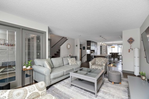 This inviting living area features light grey walls and hardwood flooring, creating a bright and airy atmosphere - 7776 Eifert Crescent Nw, Edmonton, AB - Indoor Photo Showing Living Room