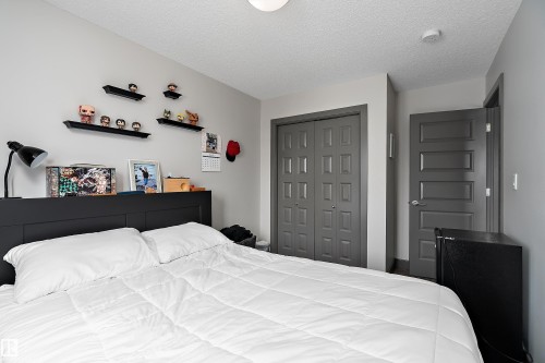 This room features light grey walls and a ceiling with a textured finish - 7776 Eifert Crescent Nw, Edmonton, AB - Indoor Photo Showing Bedroom