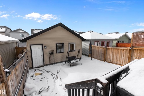 This property features a detached garage with siding and a pitched roof, alongside a fenced yard - 7776 Eifert Crescent Nw, Edmonton, AB - Outdoor With Exterior
