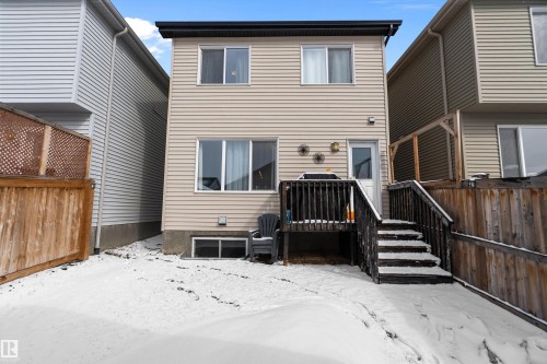 The property features a two-story exterior with light-colored siding and a dark roof - 7776 Eifert Crescent Nw, Edmonton, AB - Outdoor With Exterior