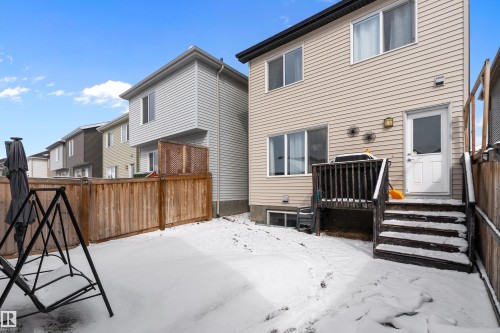 The property includes a fenced yard with a wooden deck and exterior steps - 7776 Eifert Crescent Nw, Edmonton, AB - Outdoor