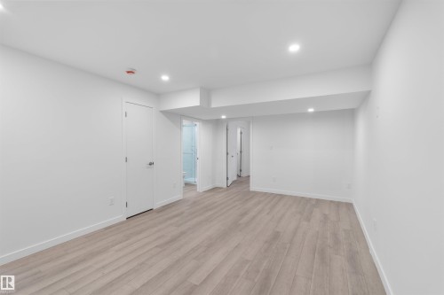 This versatile room features light-toned flooring, white walls, and recessed lighting, creating a bright and inviting atmosphere - 4016 Allan Crescent, Edmonton, AB - Indoor Photo Showing Other Room