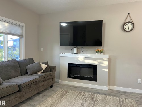 729 Berg Loop, Leduc, AB - Indoor Photo Showing Living Room With Fireplace