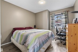 This room features wood-look flooring and a window with curtains - 