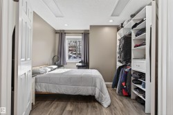 This room features built-in closet shelving, recessed lighting, and durable wood-look flooring - 