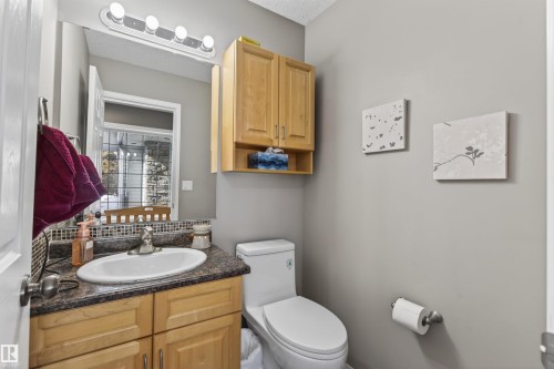 The bathroom features a vanity with a white sink, a mosaic tiled backsplash, and a light wood cabinet - #12 61212  Rr 463, Rural Bonnyville M.D., AB - Indoor Photo Showing Bathroom