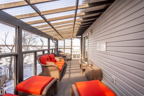 This sunroom features a clear paneled roof, full-length windows, and light gray siding - #12 61212  Rr 463, Rural Bonnyville M.D., AB -  Photo Showing Other Room