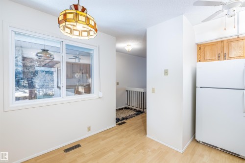 This space features light-colored flooring, white walls, and a window providing natural light - 108 Forest Grove, St. Albert, AB - Indoor