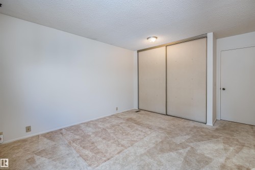 This room features carpet flooring, white walls, and a ceiling light fixture - 108 Forest Grove, St. Albert, AB - Indoor Photo Showing Other Room