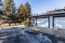 The property features a two-car garage with white panel doors and a textured exterior finish - 108 Forest Grove, St. Albert, AB  - Outdoor 