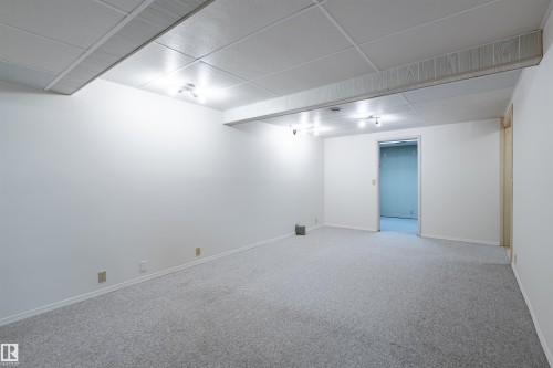 Spacious room featuring light grey carpeting, white walls, and track lighting - 108 Forest Grove, St. Albert, AB - Indoor