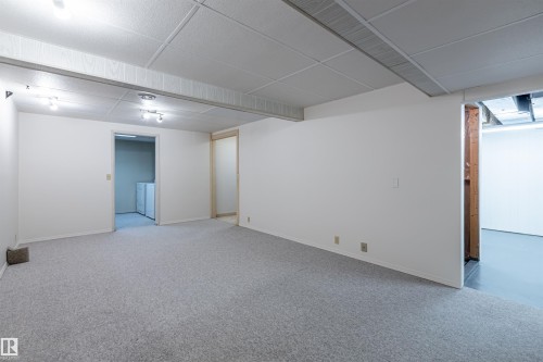 Spacious room featuring light-colored carpet, white walls, and track lighting - 108 Forest Grove, St. Albert, AB - Indoor