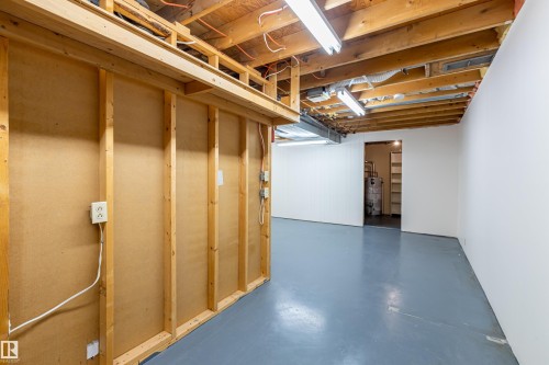 The property features an unfinished basement with exposed wooden joists and a painted concrete floor - 108 Forest Grove, St. Albert, AB - Indoor Photo Showing Basement