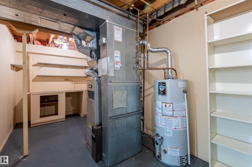 Utility room featuring a water heater, furnace, and built-in shelving - 108 Forest Grove, St. Albert, AB - Indoor Photo Showing Basement