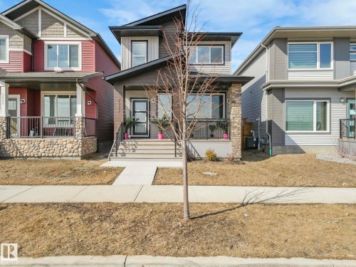 The property features a stone and siding exterior with a covered porch and front steps leading to the entrance - 2636 192 Street, Edmonton, AB - Outdoor With Deck Patio Veranda With Facade