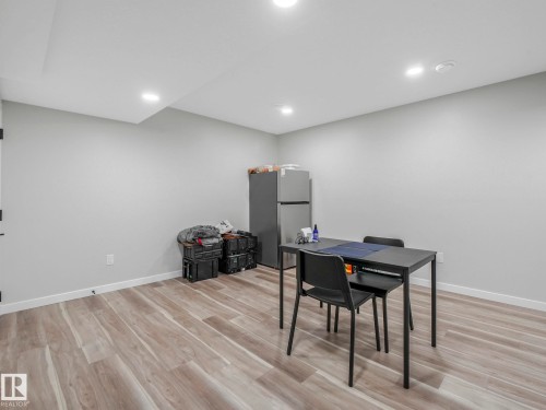 Spacious room featuring light-toned wood-style flooring, recessed lighting, and a neutral wall color - 2636 192 Street, Edmonton, AB - Indoor