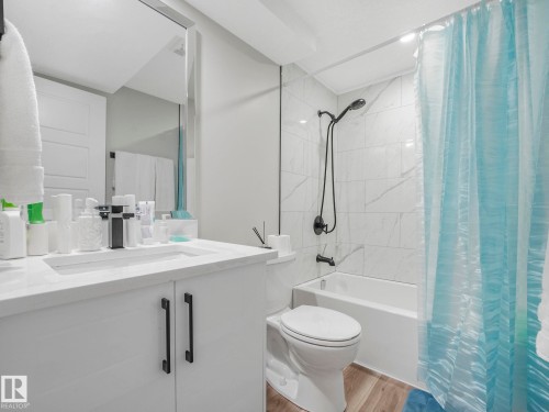 Bathroom featuring a white vanity with black hardware, a rectangular sink, and a modern black faucet - 2636 192 Street, Edmonton, AB - Indoor Photo Showing Bathroom