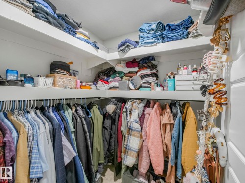A spacious walk-in closet featuring white built-in shelving and a clothing rod for ample storage - 2636 192 Street, Edmonton, AB - Indoor With Storage