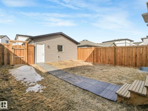 The property features a fenced yard with a detached structure, accessible via a pathway and including a gate - 2636 192 Street, Edmonton, AB - Outdoor