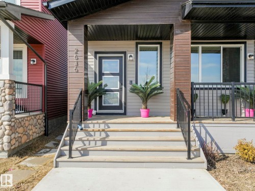 This property features a welcoming entrance with exterior stairs and black railings - 2636 192 Street, Edmonton, AB - Outdoor With Deck Patio Veranda