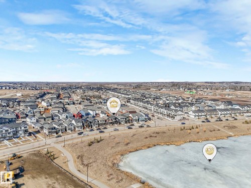 This aerial view showcases a residential area with a variety of homes, featuring both detached and attached properties - 2636 192 Street, Edmonton, AB - Outdoor With View