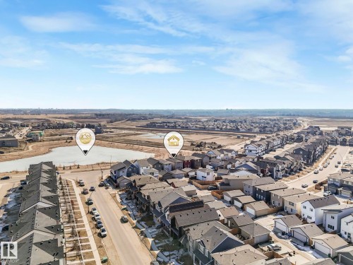 Aerial view showcasing the residential neighbourhood with a street and a lake - 2636 192 Street, Edmonton, AB - Outdoor With View