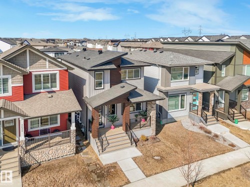 Contemporary style property with a covered entrance, a concrete walkway, and a front yard - 2636 192 Street, Edmonton, AB - Outdoor With Facade