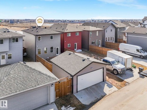 This property features a detached garage with a concrete driveway and a fenced backyard - 2636 192 Street, Edmonton, AB - Outdoor With Exterior