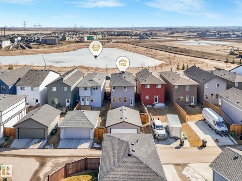 This aerial view showcases a residential property with a detached garage and a paved driveway - 2636 192 Street, Edmonton, AB - Outdoor