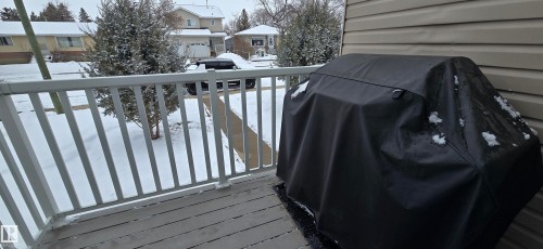 The property features a balcony with a gray railing and decking - 5514 49 Street, Vegreville, AB - Outdoor