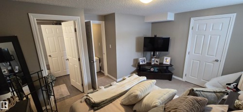 This bedroom features light gray walls, white trim, and a ceiling light fixture - 5514 49 Street, Vegreville, AB - Indoor