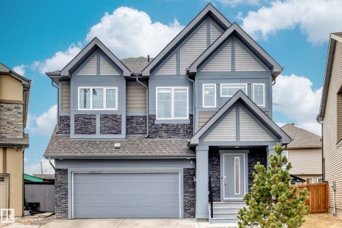 The property features a multi-level facade with gabled roof lines, stone accents, and varied siding - 922 173A Street, Edmonton, AB - Outdoor With Facade