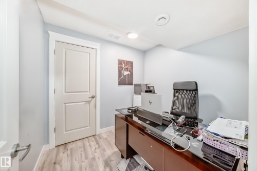 This room features light-colored walls and wood-look flooring - 922 173A Street, Edmonton, AB - Indoor Photo Showing Office