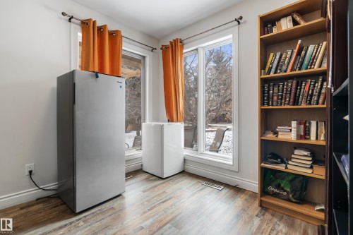 This room features wood-look flooring and two large windows with views of the outdoors - 101 Westridge Road, Edmonton, AB - Indoor