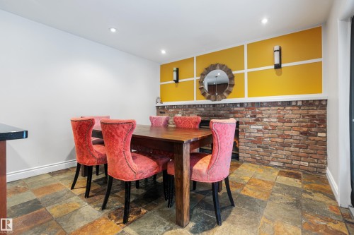 Dining area featuring multi-toned tile flooring, a brick accent wall, and recessed lighting - 101 Westridge Road, Edmonton, AB - Indoor