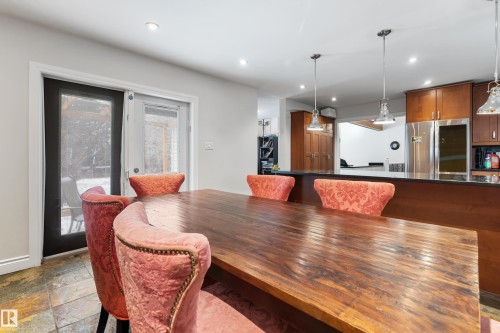 The dining area features a wooden table, recessed lighting, and patio doors - 101 Westridge Road, Edmonton, AB - Indoor Photo Showing Dining Room