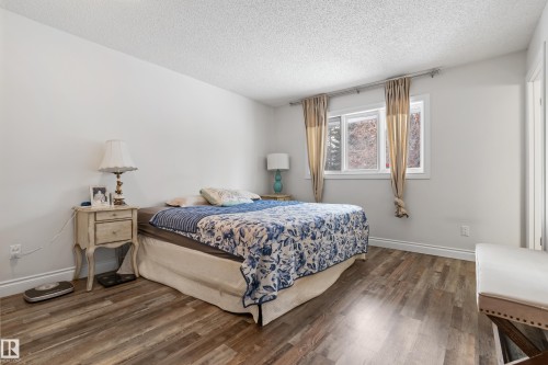 The property features a bedroom with durable wood-look flooring and light-colored walls - 101 Westridge Road, Edmonton, AB - Indoor Photo Showing Bedroom