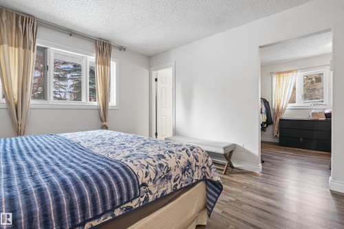 This room features light-toned walls, windows with drapes, and wood-style flooring - 101 Westridge Road, Edmonton, AB - Indoor Photo Showing Bedroom