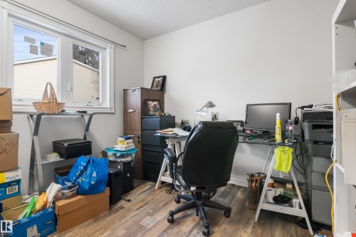 This space features wood-style flooring and white walls, creating a neutral backdrop - 101 Westridge Road, Edmonton, AB - Indoor Photo Showing Office