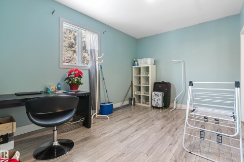 This room features light blue walls, a window with a white frame, and wood-look flooring - 101 Westridge Road, Edmonton, AB - Indoor
