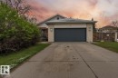 The property features a concrete driveway leading to an attached garage with a dark-colored door - 101 Westridge Road, Edmonton, AB  - Outdoor 
