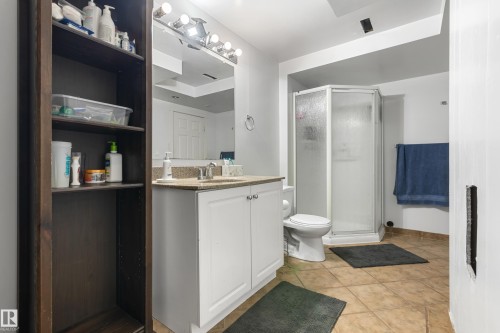 This bathroom features a white vanity with a light-colored countertop and a mirror above - 101 Westridge Road, Edmonton, AB - Indoor Photo Showing Bathroom