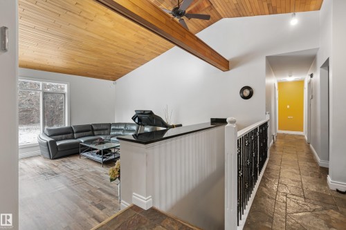 Living area featuring a vaulted wood-paneled ceiling with an exposed beam, a ceiling fan, and large windows - 101 Westridge Road, Edmonton, AB - Indoor Photo Showing Other Room