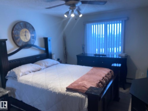The property features a room with a window, vertical blinds, and a ceiling fan with integrated lighting - 336 9525 162 Avenue, Edmonton, AB - Indoor Photo Showing Bedroom