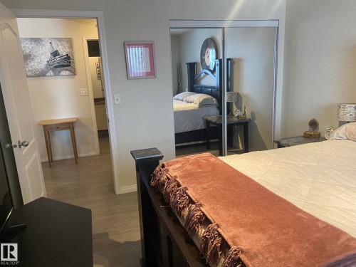 This bedroom features light-colored walls and grey wood-style flooring - 336 9525 162 Avenue, Edmonton, AB - Indoor Photo Showing Bedroom