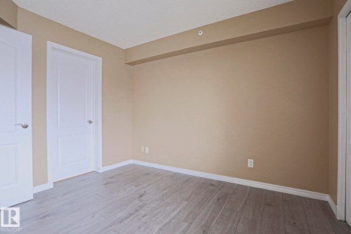 This room features light-colored flooring, beige walls, and white trim - 201 10909 103 Avenue Nw, Edmonton, AB - Indoor Photo Showing Other Room